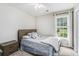 Inviting bedroom with a comfortable bed, a window for natural light, and neutral decor at 3117 Blowing Wind Nw Ct, Acworth, GA 30101