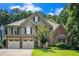 Charming two-story home featuring a brick and siding exterior, well-manicured lawn, and an attached two-car garage at 3117 Blowing Wind Nw Ct, Acworth, GA 30101
