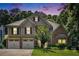 Beautiful two-story home with a brick and siding exterior, three-car garage, and well-manicured lawn at 3117 Blowing Wind Nw Ct, Acworth, GA 30101