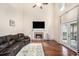 Spacious living room with a fireplace, hardwood floors, and ample natural light, creating a welcoming atmosphere at 3117 Blowing Wind Nw Ct, Acworth, GA 30101
