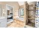 Luxurious bathroom featuring a tile shower, soaking tub, and adjacent main bedroom at 3117 Blowing Wind Nw Ct, Acworth, GA 30101