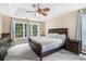 Bright main bedroom featuring large windows, a ceiling fan, and comfortable furnishings at 3117 Blowing Wind Nw Ct, Acworth, GA 30101