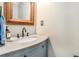 Stylish powder room featuring a granite countertop, a wood-framed mirror, and sleek fixtures at 3117 Blowing Wind Nw Ct, Acworth, GA 30101