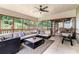 Relaxing screened porch features comfortable seating, a ceiling fan, and natural light at 3117 Blowing Wind Nw Ct, Acworth, GA 30101