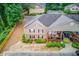 Backyard view of a townhouse exterior with a private balcony surrounded by green foliage and mature trees at 405 Brighton Pt, Atlanta, GA 30328