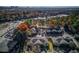 Community aerial view of townhouse complex with mature trees and ample parking, city skyline in the distance at 405 Brighton Pt, Atlanta, GA 30328