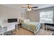 Cozy bedroom with neutral tones, ceiling fan, and a work area featuring a desk and chair at 405 Brighton Pt, Atlanta, GA 30328