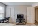 Bedroom featuring a tv, two entry doors, neutral paint, and carpeted floors at 405 Brighton Pt, Atlanta, GA 30328