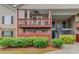 Close up of townhouse with red wood balconies and covered decks surrounded by lush greenery at 405 Brighton Pt, Atlanta, GA 30328