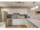 Renovated kitchen boasts white cabinets, stainless steel appliances, and gray countertops at 405 Brighton Pt, Atlanta, GA 30328