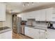 Updated kitchen features stainless steel appliances, white cabinets and gray subway tile backsplash at 405 Brighton Pt, Atlanta, GA 30328