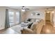 Cozy living room with a large sectional sofa, and sliding glass doors at 405 Brighton Pt, Atlanta, GA 30328