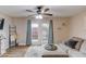 Living room with stylish furnishings, a ceiling fan, and sliding glass doors offering outdoor views at 405 Brighton Pt, Atlanta, GA 30328