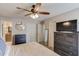 Spacious primary bedroom includes ceiling fan, dresser, TV, and access to the bathroom at 405 Brighton Pt, Atlanta, GA 30328