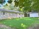 Expansive green backyard featuring a storage shed on a sunny day, partially obscured by trees at 413 Old Brock Rd, Rockmart, GA 30153