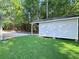 Backyard featuring a spacious shed with an open shelter and lush green lawn at 413 Old Brock Rd, Rockmart, GA 30153