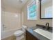 Bathroom featuring a shower-tub combo, toilet, and a gray vanity with a sink at 413 Old Brock Rd, Rockmart, GA 30153