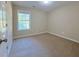 Inviting bedroom with neutral carpeting, window, and a door leading to other parts of the house at 413 Old Brock Rd, Rockmart, GA 30153