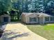 Charming home and detached shed with a freshly poured concrete driveway and landscaped yard at 413 Old Brock Rd, Rockmart, GA 30153