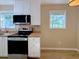 Bright kitchen with white cabinets, stainless steel appliances, butcher block counters, and wood-look floors at 413 Old Brock Rd, Rockmart, GA 30153