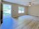 Open-concept living room with wood-look flooring and views of the backyard and the patio at 413 Old Brock Rd, Rockmart, GA 30153