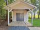 Outdoor shed featuring double doors, a front porch, and a shingled roof at 413 Old Brock Rd, Rockmart, GA 30153