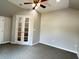 Bedroom featuring glass panel doors and neutral carpeting at 4185 Lenox Park Dr, Buford, GA 30519