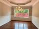 Bright dining room featuring hardwood floors, decorative ceiling, and a charming crystal chandelier at 4185 Lenox Park Dr, Buford, GA 30519