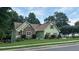 Charming home with a stone facade and red shutters on a well-manicured lawn at 4185 Lenox Park Dr, Buford, GA 30519