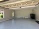 Spacious two car garage featuring epoxy floor, overhead storage and natural light at 4185 Lenox Park Dr, Buford, GA 30519