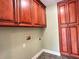 Well-organized laundry room with custom wood cabinetry and utility connections at 4185 Lenox Park Dr, Buford, GA 30519