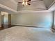 Open Living room with trey ceilings, hardwood floors, and ample space at 4185 Lenox Park Dr, Buford, GA 30519