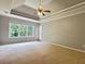 Spacious main bedroom with a trey ceiling, large windows, and a ceiling fan at 4185 Lenox Park Dr, Buford, GA 30519