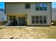 View of home's back exterior, with a covered patio and well-maintained lawn at 574 Friars Head Dr, Suwanee, GA 30024