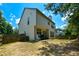 A view of the home's back exterior with a cozy patio area and fenced-in yard at 574 Friars Head Dr, Suwanee, GA 30024