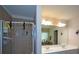 Modern bathroom featuring tiled walk-in shower, dual sinks and a large mirror at 574 Friars Head Dr, Suwanee, GA 30024