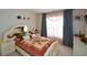 Bedroom featuring a unique bed frame, neutral walls, and soft natural lighting at 574 Friars Head Dr, Suwanee, GA 30024