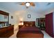 Comfortable bedroom featuring a leaf ceiling fan, wood furnishings and neutral wall color at 574 Friars Head Dr, Suwanee, GA 30024