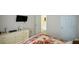 Cozy bedroom with neutral tones, a flat-screen TV, and an open doorway at 574 Friars Head Dr, Suwanee, GA 30024