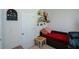 Small bedroom with a red daybed, unique decor, and natural lighting at 574 Friars Head Dr, Suwanee, GA 30024