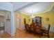 Bright dining room with hardwood floors, chandelier, and classic decor at 574 Friars Head Dr, Suwanee, GA 30024