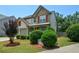 View of the front lawn with mature shrubs and red mulch at 574 Friars Head Dr, Suwanee, GA 30024