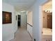Hallway features neutral carpet, artwork and leads to the bathroom and bedrooms at 574 Friars Head Dr, Suwanee, GA 30024