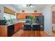 Well-equipped kitchen with stainless steel appliances, an island with seating, and ample wooden cabinetry at 574 Friars Head Dr, Suwanee, GA 30024