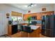 Well-equipped kitchen with stainless steel appliances, an island with seating, and ample wooden cabinetry at 574 Friars Head Dr, Suwanee, GA 30024