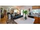 Open concept kitchen with granite countertops and island seating flows into the living room at 574 Friars Head Dr, Suwanee, GA 30024