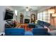 Comfortable living room with a fireplace, ceiling fan and cozy blue sectional sofa at 574 Friars Head Dr, Suwanee, GA 30024