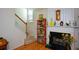 Living room with a fireplace, white staircase and hardwood floors at 574 Friars Head Dr, Suwanee, GA 30024