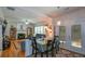 Inviting living space with fireplace, seamlessly connected to the dining area, and hardwood floors at 574 Friars Head Dr, Suwanee, GA 30024