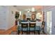 Inviting living space with fireplace, seamlessly connected to the dining area, and hardwood floors at 574 Friars Head Dr, Suwanee, GA 30024